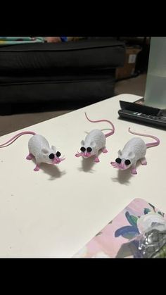 three plastic mice sitting on top of a table