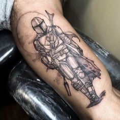 a man's arm with a tattoo on it that has a drawing of a motorcycle