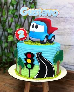 a birthday cake that is decorated with cars