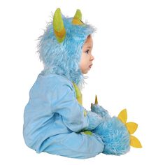 a little boy dressed in a blue costume with yellow horns on his head and legs