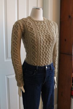 a mannequin is wearing a sweater and jeans