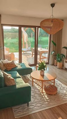 a living room filled with furniture and a large glass door leading to an outside deck