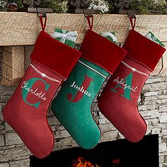 three christmas stockings hanging from a fireplace