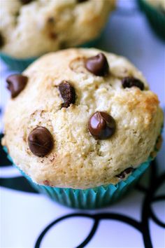 two chocolate chip muffins sitting on top of a table