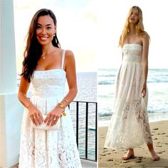 a woman in a white dress standing on the beach with her hands in her pockets