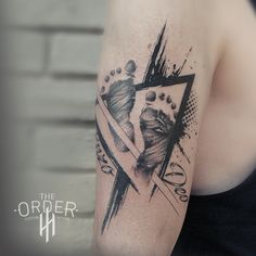 a woman's arm with a black and white tattoo design on her left shoulder