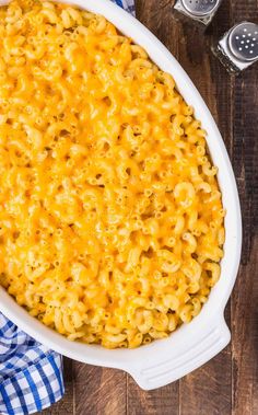 macaroni and cheese in a white casserole dish on a wooden table