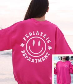 "This Pediatrics Department Sweatshirt / Pediatric Nurse Crewneck Sweater is cute and trendy and so warm and cozy - perfect for those chilly days in the PEDS unit! *FRONT & BACK PRINT* See more of our Pediatrics Merch here!: https://www.etsy.com/shop/SketchyCatDesigns?search_query=pediatric Say hello to your new favorite sweatshirt! It's a go-to classic lounge-able sweatshirt, that's also perfect for wearing out and about! Whether your day will consist of running errands, walking your pooch, goi Playful Crew Neck T-shirt For Loungewear, Cute Long Sleeve Sweatshirt For School, Cute Cotton Sweatshirt For Loungewear, Fun Crew Neck Winter Sweatshirt, Playful Crew Neck Winter Sweatshirt, Cute Cotton School Sweater, Fun Winter Crew Neck Sweatshirt, Cute Winter Sweatshirt For School, Playful Winter Crew Neck Sweatshirt