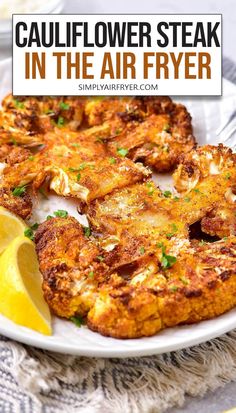 cauliflower steak in the air fryer on a plate with lemon wedges