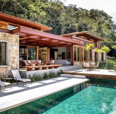 an outdoor living area next to a swimming pool