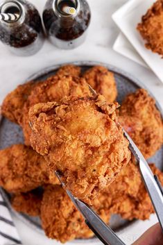 a person holding a fork with some fried food on it