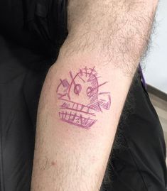 a man's arm with a tattoo on it that has an image of a smiling face