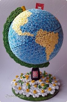 the earth is made out of legos and has flowers growing on top of it