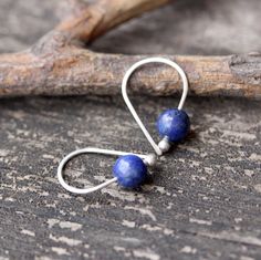 "Lapis lazuli sterling silver earrings Dainty 3/4\" sterling silver budded open hoops with 6mm dark blue pyrite flecked lapis lazuli stones. Made to order ~ minor variations in stone character ♥ Open hoops are applied to your ears by grasping the open ends in each hand and gently pulling one end up and one end down, then simply slide them in your ear. DO NOT pry them open then pinch them closed, they will lose shape and not close properly. HOW TO properly put on any kind of hoop earring. Copy an Handmade Lapis Lazuli Jewelry For Everyday, Unique Handmade Sterling Silver Cartilage Earrings, Minimalist Handmade Dangle Cartilage Earrings, Minimalist Sterling Silver Earrings With Natural Stones, Minimalist Blue Wire Wrapped Earrings, Handmade Minimalist Drop Cartilage Earrings, Nickel-free Blue Cartilage Earrings As Gift, Dainty Handmade Drop Cartilage Earrings, Handmade Minimalist Lapis Lazuli Jewelry