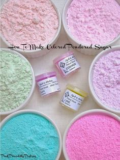 several different colored powders in bowls with labels on the bottom and one is pink, blue