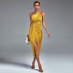 a woman in a yellow dress posing for the camera with her hand on her hip