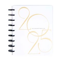 a spiral bound notebook with the number twenty five in gold and black on white paper