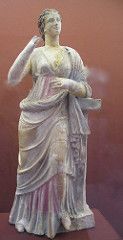 a statue of a woman holding a book