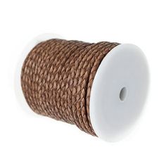 a spool of brown rope on a white background