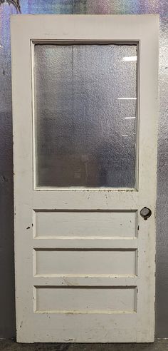 an old white door on the side of a building