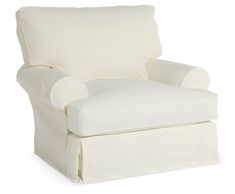 a white chair with a pillow on it's back and foot rests against the wall