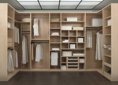 an open closet with lots of white clothes