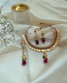 "Our lightweight Lakshmi coin choker boasts a stunning gold plating and a unique embossed Lakshmi coin adorned with faux ruby and emerald stones. It perfectly complements traditional sarees and is ideal for weddings, Indian festivals, or Bollywood-themed parties. It is also a popular choice for Indian classical dance performances like Bharatnatyam. The set includes matching earrings and tikka, making it a festive must-have. Step into timeless elegance with our Traditional South Indian Gold Coin Necklace Set. This exquisite temple jewelry is a must-have for vintage antique jewelry enthusiasts. In South India, coin jewelry is known as Kasumala. This Kasumala choker, made with closely strung gold coins that beautifully overlap each other, is an essential piece in every South Indian woman's je Traditional Gold Coin Necklace For Festivals, Traditional Coin Necklace For Festivals And Gifts, Gold Coin Necklace For Festivals, Traditional Handmade Gold Coin Necklace, Lakshmi Jewellery, Coin Choker, Indian Classical Dance, Temple Jewelry, Classical Dance