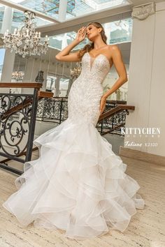 a woman in a wedding dress posing for the camera with her hand on her face