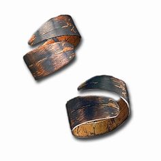 two rings made out of wood on a white background