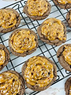 chocolate cookies with caramel frosting and pecans on a cooling rack, ready to be eaten