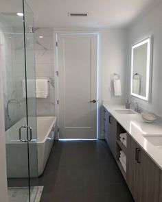 a large bathroom with two sinks and a bathtub in it's center area