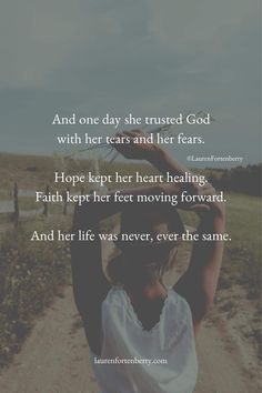 a woman walking down a dirt road with her hands up to her head and the words, and one day she trusts god with her tears and her fear