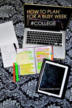 an open laptop computer sitting on top of a bed next to a notebook and pen