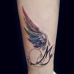 a colorful feather tattoo with the letter m on it's side calfockse