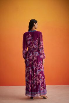 A kaftan-inspired silhouette, the Maheen Long Dress is from the Ramadan'24 collection. Crafted in flowy viscose crinkle chiffon and dipped in a royal purple hue, the dress features an elegant V-Neck and bishop sleeves, and is gently fitted at the waist before cascading down to the ankles. The darling floral print lends festive flair to this versatile style! The dress comes with a zipper closure. Made In India Purple Floral Print Viscose Crinkle Chiffon Shell - 100% Viscose Lining- 80% Nylon 20% Hemant And Nandita, Purple Floral Print, Royal Purple, Purple Hues, Versatile Style, Purple Floral, Ramadan, Long Dress, The Dress