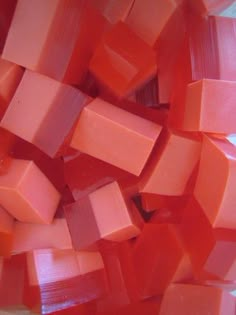 cubes of orange and pink colored food sitting on top of each other