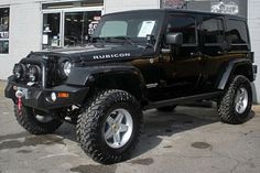 a black jeep parked in front of a building