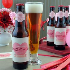 there are many bottles and glasses on the table with pink streamers around each bottle