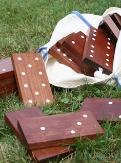 several pieces of wood sit on the ground in front of a white bag with polka dots