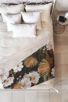 an overhead view of a bed with flowers on it