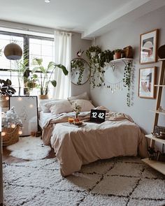 a bed room with a neatly made bed and lots of plants