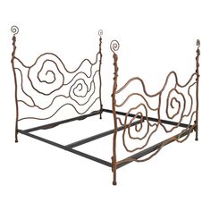 a metal bed frame with intricate designs on the headboard and foot board is shown against a white background