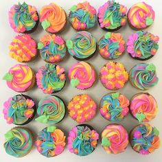 there are many cupcakes with different colored frosting