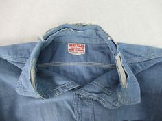 "Vintage 1940s work shirt. Made of cotton chambray. Color is medium blue. Has a button down front, button cuffs, two chest pockets and triple stitched seams. Hercules work clothing by Sears. Size medium. Actual measurements are: 43\" at the chest 42\" at the waist 16\" shoulder seam to shoulder seam 25\" shoulder seam to cuff 32\" overall length In good condition with a worn through collar and some minor paint spots." Cheap Workwear Shirt With Back Button Closure, Luxury Workwear Shirt With Snap Buttons, Cheap H&m Workwear Shirt, Affordable H&m Workwear Shirt, Cheap Workwear Shirt With Shirttail Hem, Affordable Classic Workwear Shirt, Cheap Washed Blue Workwear Shirt, Luxury Vintage Workwear Shirt, Classic Cheap Shirt With Patch Pockets