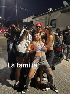 some people are posing for a photo in front of a car with the words la familia written on it