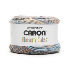 yarn that is blue, brown and white with the words carbon blossom cakes on it