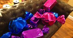 many wrapped presents are sitting on the couch