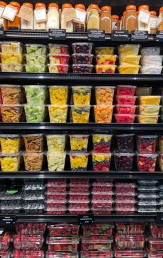 a display in a grocery store filled with lots of fruits and vegetables