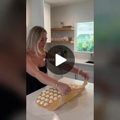 a woman is making cookies on a counter