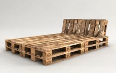 a bed made out of wooden pallets sitting on top of a white floor next to a wall